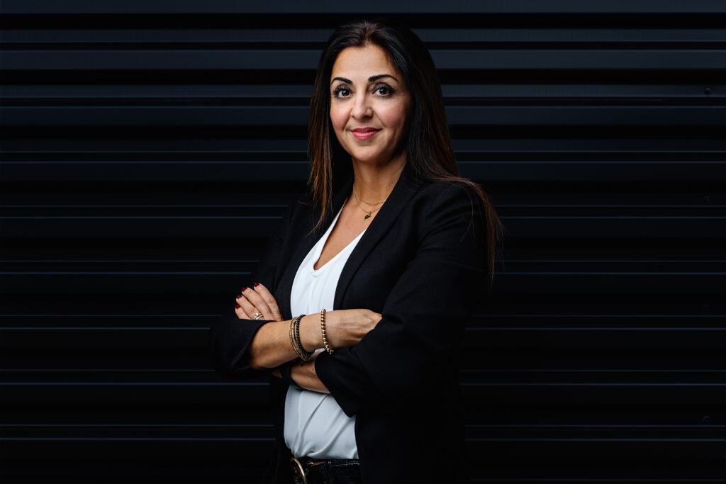 Ausdrucksstarkes Porträt einer Mitarbeiterin vor einem dunklen Hintergrund in Ulm.